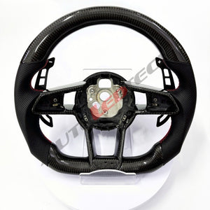 Audi R8 magnetic paddle shifters installed on carbon fiber steering wheel