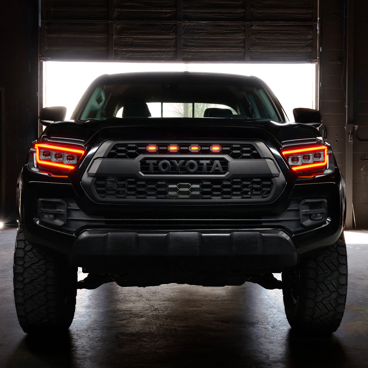 Tacoma with ORACLE Lensless headlights illuminated at night
